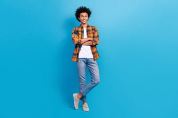 Full length photo of cheerful confident guy wear plaid shirt smiling arms crossed isolated blue color background