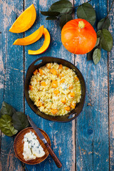 Traditional Italian risotto with Hokkaido pumpkin and gorgonzola soft cheese served as top view in a Nordic design bowl