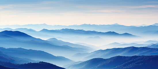 Swiss Alps blue mountain silhouettes seen from Mt Niesen during an autumn evening With copyspace for text
