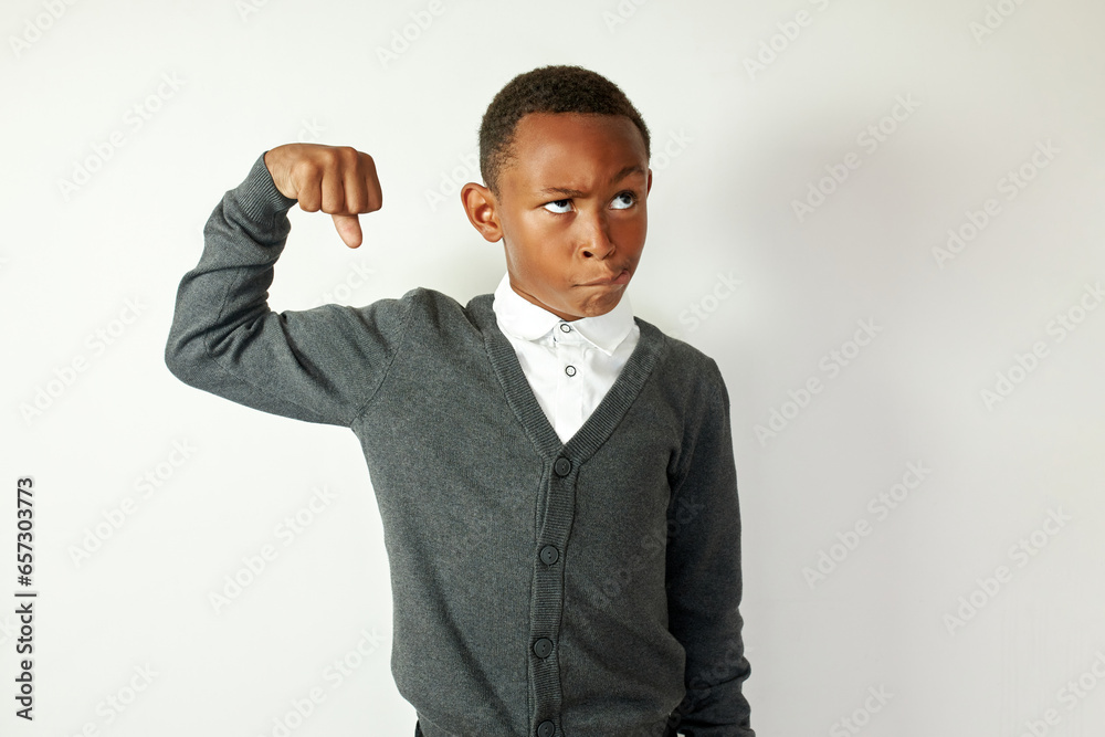 Wall mural portrait of funny black male school kid in gray cardigan and formal shirt making faces pretending be