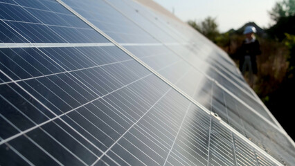Obraz premium Closeup of surface of blue photovoltaic solar panels mounted on building roof for producing clean ecological electricity. Production of renewable energy concept.