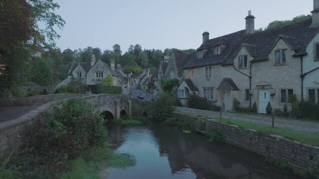 Cinematic low drone shot of Castle Combe in the Cotswolds, UK