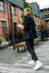 Young business woman in black suit feeling excited and contented