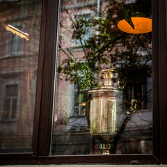 Samovar in window, old city reflection on glass