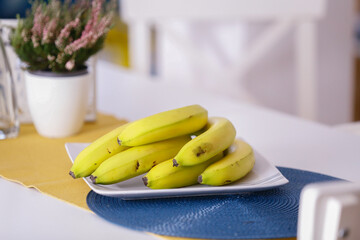 Green unripe bananas in the kitchen