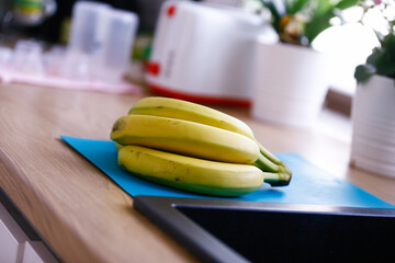 Green unripe bananas in the kitchen