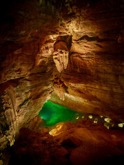 View of an emerald green underground lake inside the Grotte de Trabuc, Gard, France