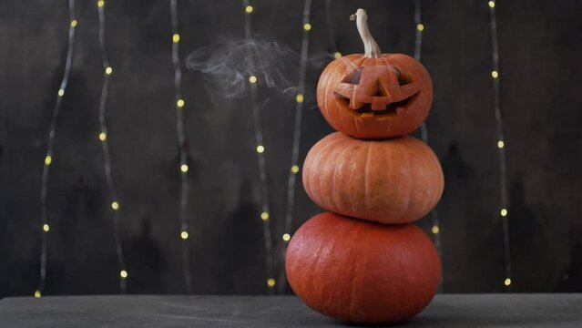 Halloween pumpkin piramid with smoke rising from eyes 
