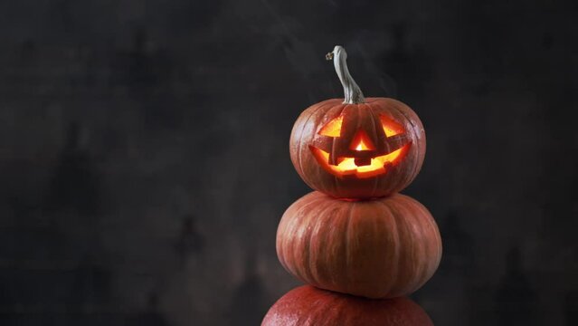 Halloween pumpkin piramid with smoke rising from eyes 