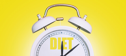 Vintage white clock with diet time on yellow background. Time to diet, creative idea. Losing...