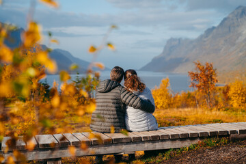 A middle aged couple watching over Ersfjord, Autumn in Tromso and it's neighbouring island Kvaloya - 657325741