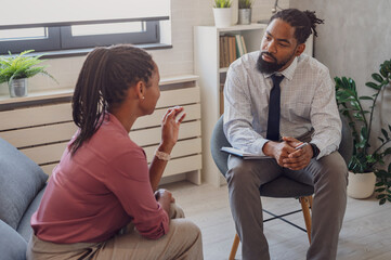A psychotherapist session with a patient. African American woman and man have a meeting.  - obrazy, fototapety, plakaty
