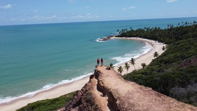 people enjoying a view of the sea up in the cliff. Conde, Coqueirinho beach, Para&iacute;ba, brasil
