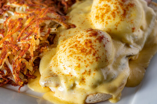 Closeup of eggs benedict with hash browns