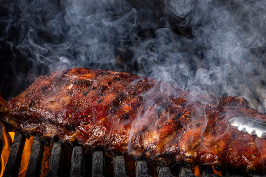 Ribs on a grill with smoke