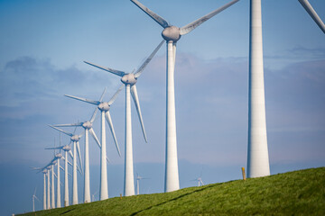 wind turbine in the wind on a green field