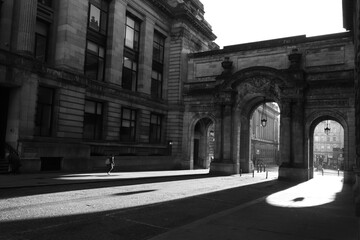United Kingdom, Glasgow - City of Glasgow in the UK. Bright sunny day, play of light and shadow, illuminated historical part of the city. A cozy old building, the historical heritage of the city