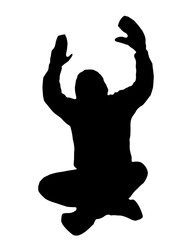silhouette of a man sitting with his hands up
