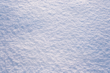 Snow surface close-up. Winter sunny day, frosty mood. Natural texture background. Copy space, top view.