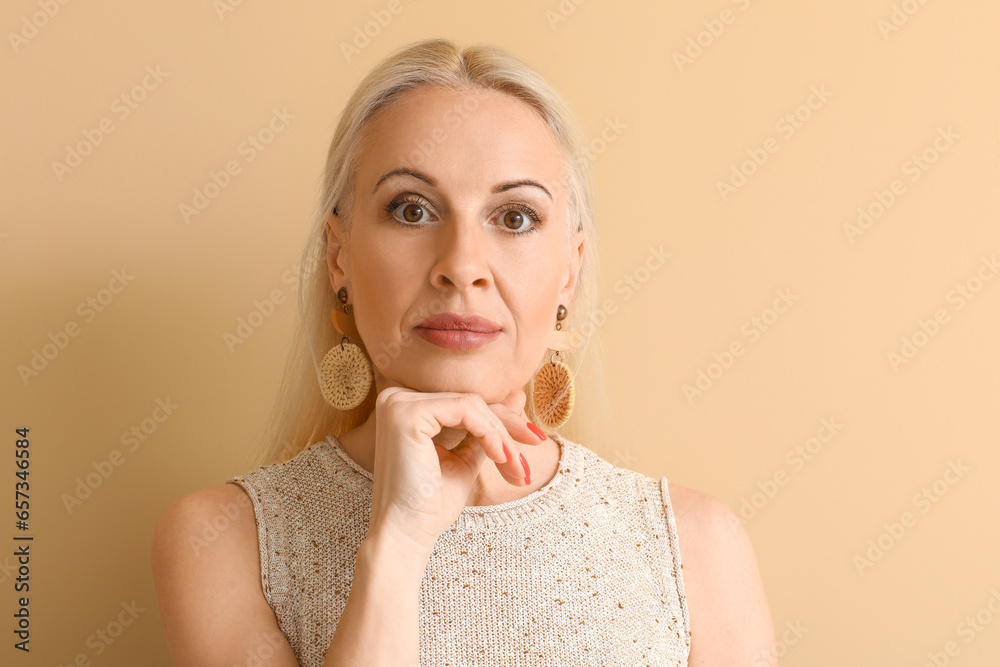 Sticker mature blonde woman on beige background, closeup