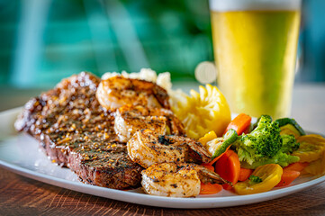 New York Strip with a Blackened Shrimp Skewer over Mashed Potatoes.