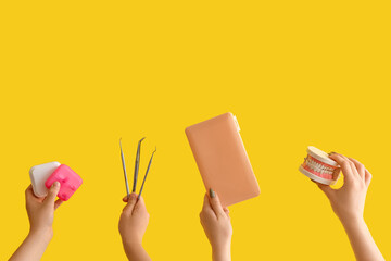 Women with dental tools on yellow background