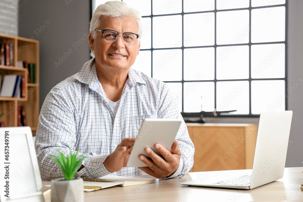 Canvas Prints Senior man using tablet computer at home