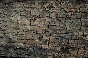 Zelfklevend Fotobehang Texture of the cracked flat surface of dark сharred wood. Burnt wooden board.v © nskyr2