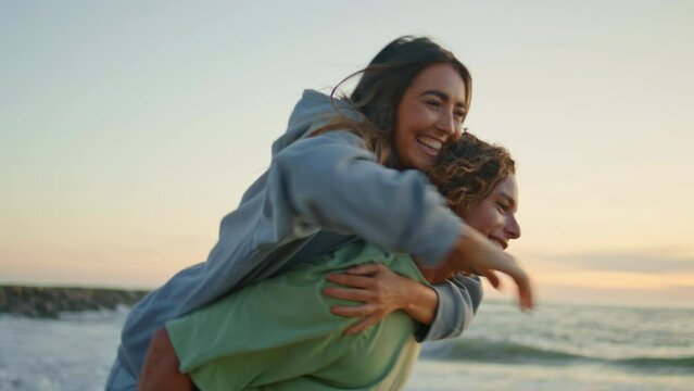 Excited girl jumping boyfriend back sundown closeup. Happy man piggyback woman
