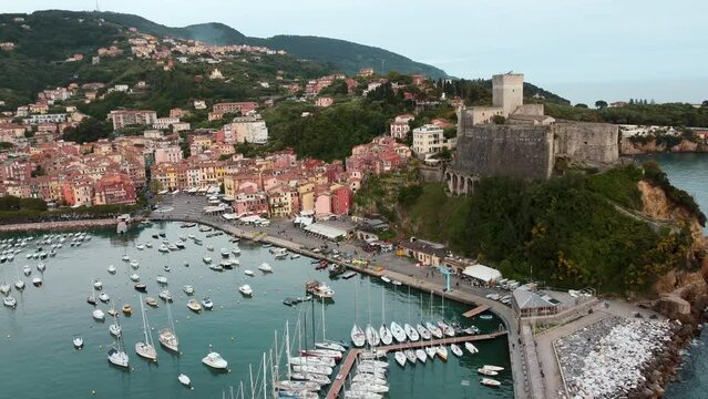 Italy, Liguria, aerial view of Lerici, a beautiful seaside village, its castle and port with moored boats