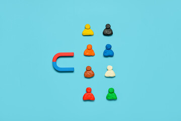Magnet with group of customers on blue background. Marketing concept
