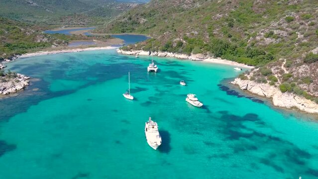 Splendid bay with turquoise water and boats anchored at anchor, aerial shots