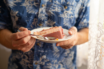 A man eating cake with a spoon.