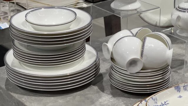 New stacked plates and cups in the crockery store or tableware shop