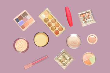 Different cosmetic products flying on lilac background