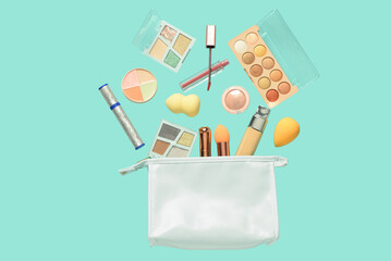 Flying bag with decorative cosmetics on color background