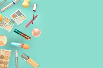 Different flying decorative cosmetics on color background