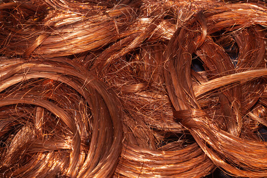 Scrap copper stripped cables twisted and collected in a heap, close-up.