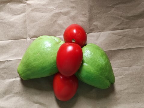 Fresh vegetables, chayotes, tomatoes on a paper background, coffee in a supermarket in Mexico,Verduras frescas,&nbsp; chayotes,jitomates en un fondo de papel, caf&eacute; en un supermercado de M&eacute;xico