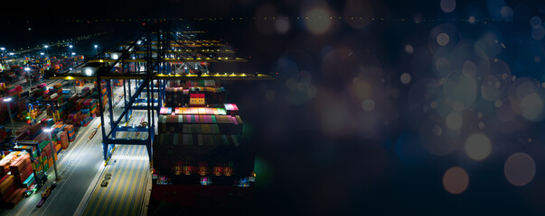 Rear view of container ship loading and unloading at cargo shipping port at night, freight...