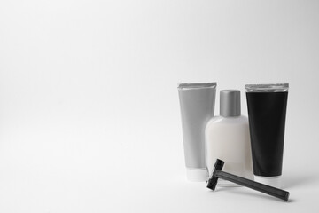 Different men's shaving accessories on white background. Space for text