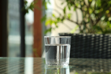 Glass of fresh pure water on table