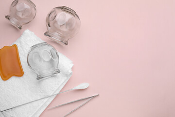 Flat lay composition with glass cups on pink background, space for text. Cupping therapy