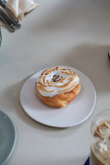 Lemon meringue donut on white plate.  Sweet summer dessert. Minimal concept. Doughnuts and bakery.