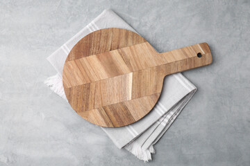 One wooden cutting board on light grey table, top view. Cooking utensil