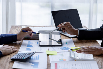 Business People Meeting using chart graph calculator, laptop computer,stock market chart paper for analysis Plans to improve quality next month, Conference Discussion Corporate Concept.	