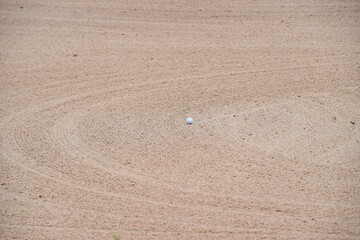 Fototapeta na wymiar golf ball on the sand