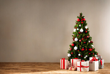 Christmas tree decorated with beautiful shiny baubles and presents on wooden floor. Space for text