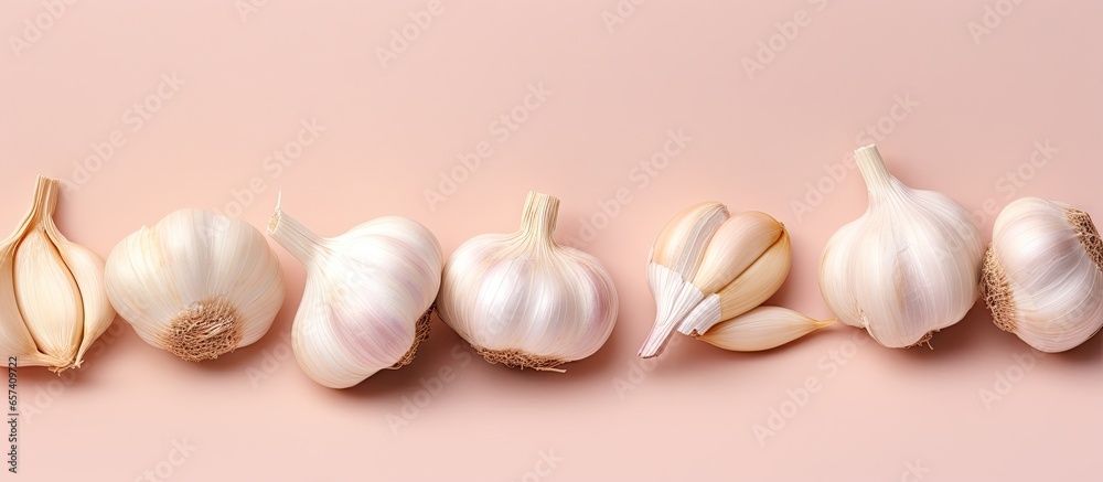 Poster Raw garlic cloves isolated on a isolated pastel background Copy space with clipping path