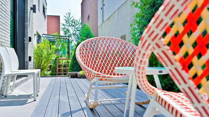 Colorful rattan chairs are always available in resort accommodations - obrazy, fototapety, plakaty